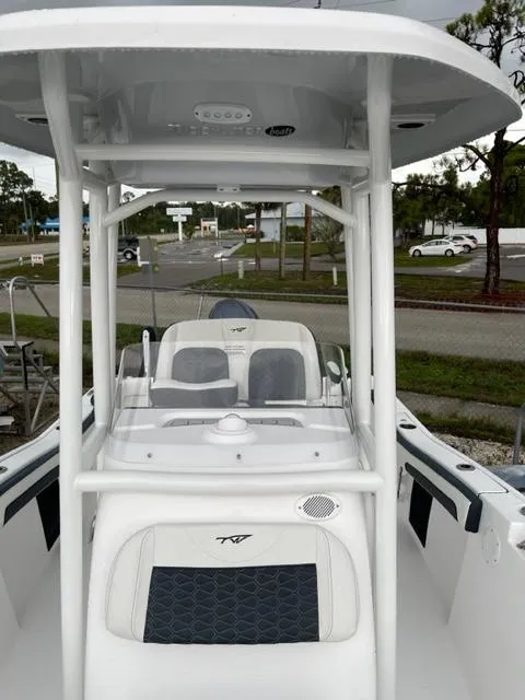 Slide: The Image of 2024 Tidewater 210 LXF boat, white exterior, center console, parked outdoors. - 10