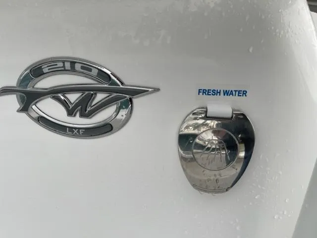 Slide: The Image of 2024 Tidewater 210 LXF boat emblem and fresh water access. - 11