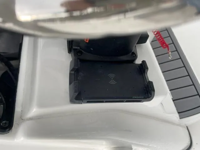 Slide: The Image of 2024 Tidewater 210 LXF boat console with wireless charging pad. - 13