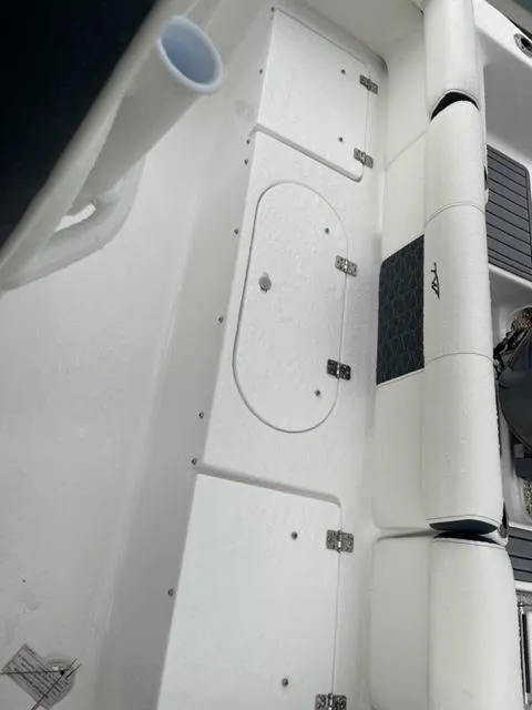 Slide: The Image of 2024 Tidewater 210 LXF boat interior with storage compartments and seating. - 14