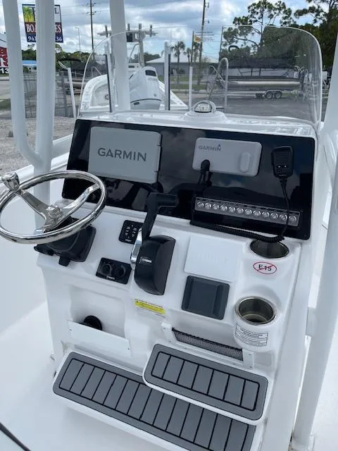 Slide: The Image of 2024 Tidewater 210 LXF boat console with Garmin navigation system and steering wheel. - 18