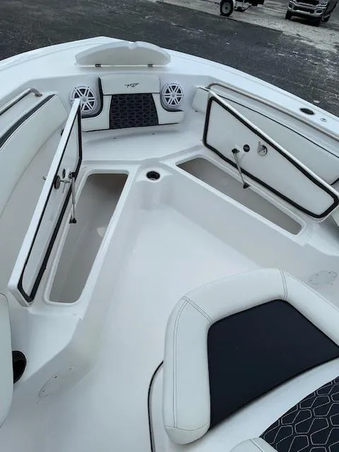 Slide: The Image of 2024 Tidewater 210 LXF boat interior with open storage compartments and seating. - 21