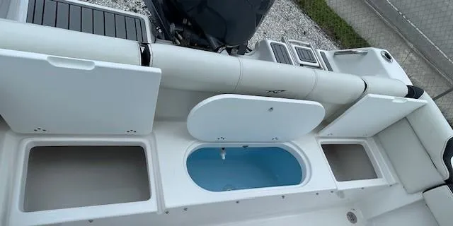 Slide: The Image of 2024 Tidewater 210 LXF boat interior with storage compartments and seating. - 25