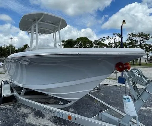 Slide: The Image of 2024 Tidewater 210 LXF boat on trailer under cloudy sky. - 26