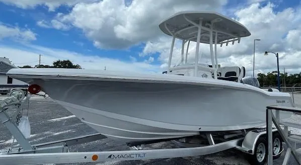 Slide: The Image of 2024 Tidewater 210 LXF boat on trailer under cloudy sky. - 27