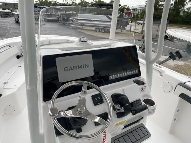 Slide: The Image of 2024 Tidewater 210 LXF boat console with Garmin navigation system and steering wheel. - 4
