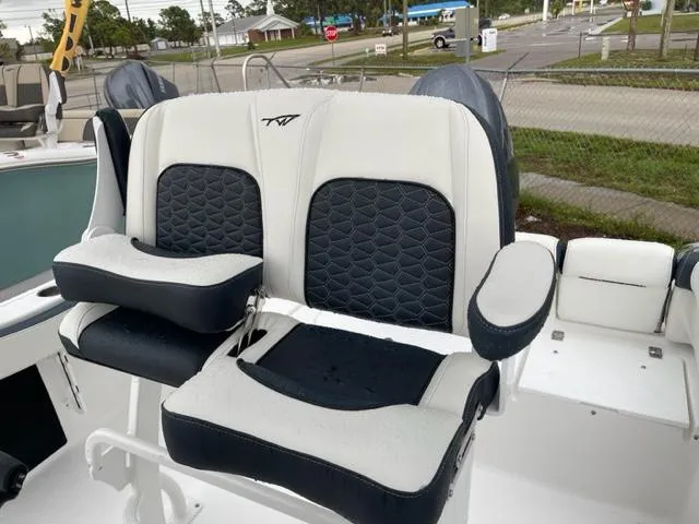 Slide: The Image of 2024 Tidewater 210 LXF boat seats, featuring black and white cushioned design. - 6