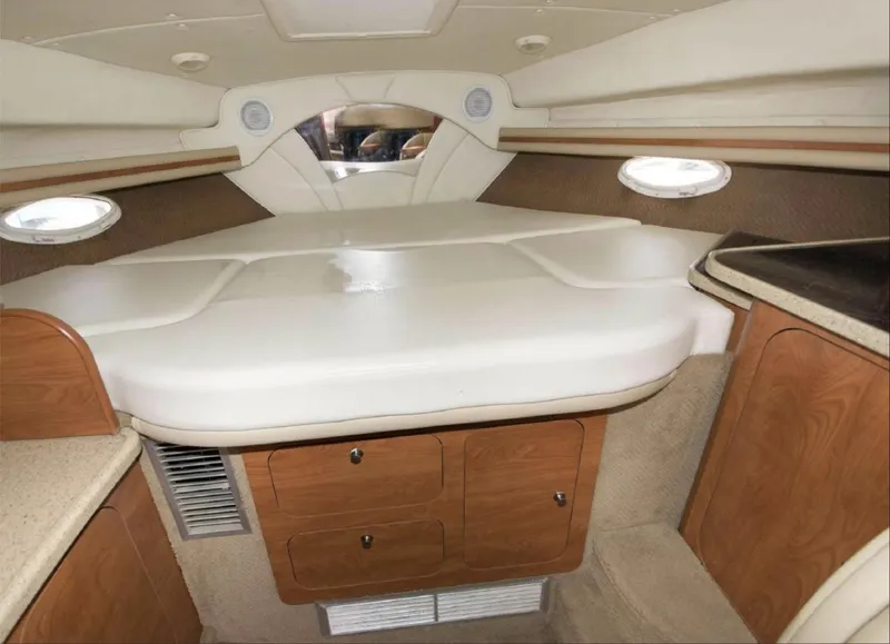 Slide: The Image of Interior cabin of a 2006 Rinker 342 Express Cruiser with bed and storage cabinets. - 12