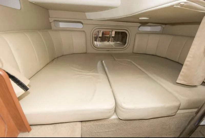 Slide: The Image of 2006 Rinker 342 Express Cruiser interior cabin with beige upholstery. - 13