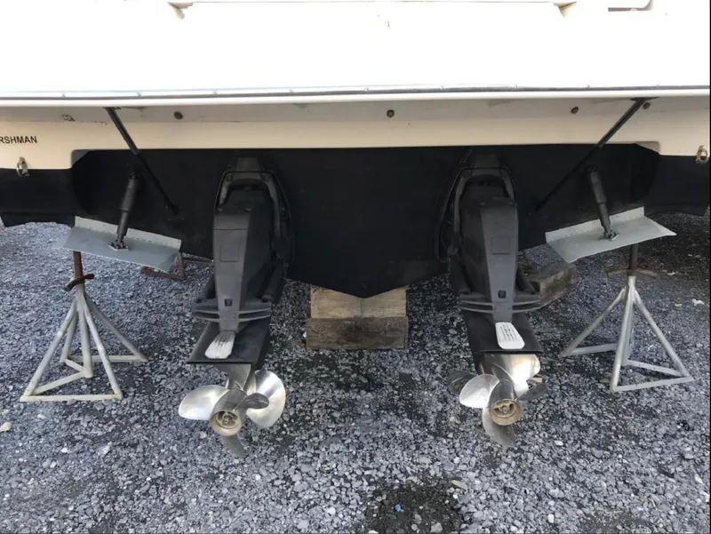 Slide: The Image of 2006 Rinker 342 Express Cruiser dual propellers on gravel. - 16