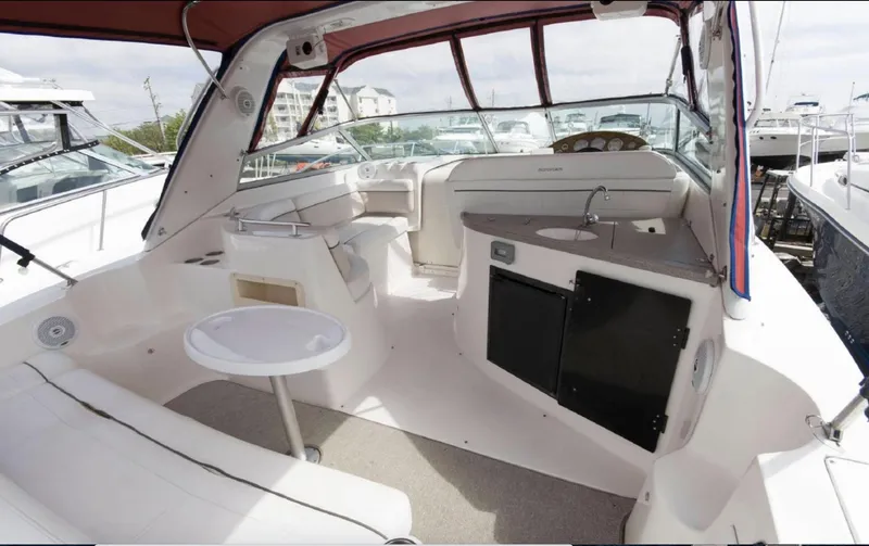 Slide: The Image of 2006 Rinker 342 Express Cruiser interior with seating, table, and kitchenette. - 4