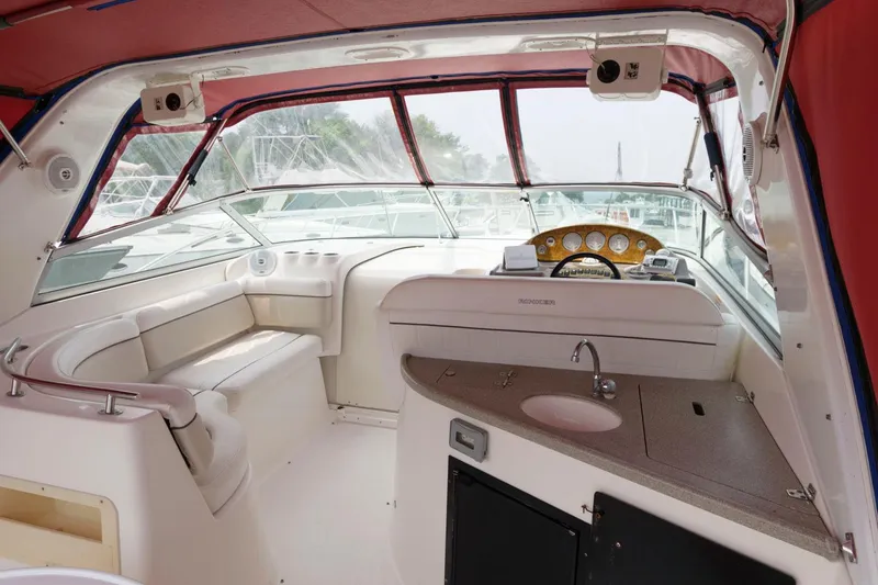 Slide: The Image of 2006 Rinker 342 Express Cruiser cockpit with seating, helm, and sink. - 5