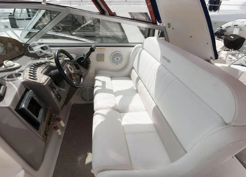 Slide: The Image of 2006 Rinker 342 Express Cruiser cockpit with white seating and control panel. - 6