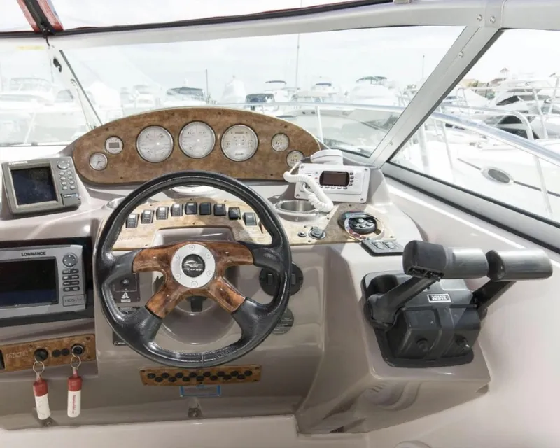 Slide: The Image of 2006 Rinker 342 Express Cruiser helm with steering wheel, gauges, and navigation equipment. - 7