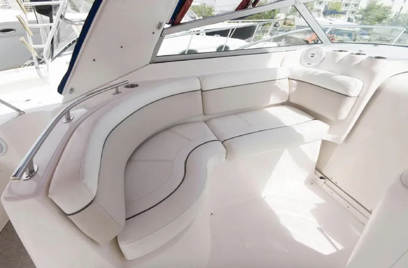 Slide: The Image of 2006 Rinker 342 Express Cruiser interior seating area with white upholstery. - 8