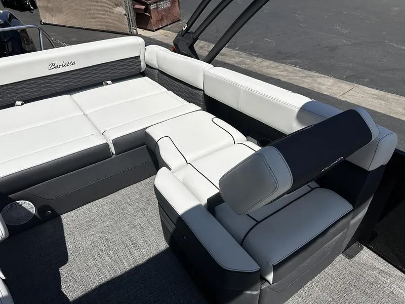 Slide: The Image of 2023 Barletta 23UA boat interior with white and black seating. - 12