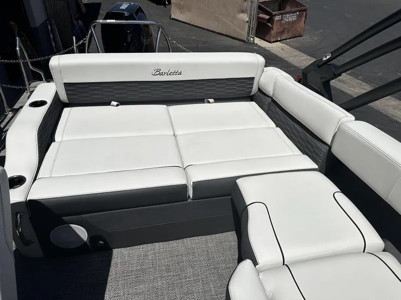 Slide: The Image of 2023 Barletta 23UA boat interior with white and gray cushioned seating. - 13