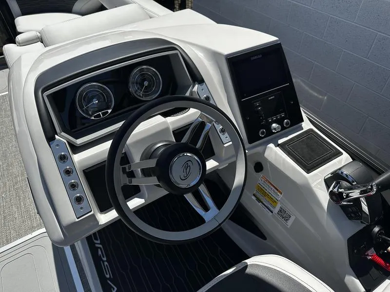 Slide: The Image of 2023 Barletta 23UA boat dashboard with steering wheel and control panel. - 17