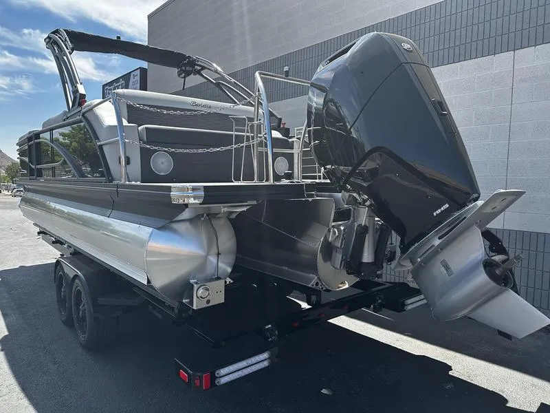 Slide: The Image of 2023 Barletta 23UA pontoon boat with powerful outboard motor on trailer. - 5