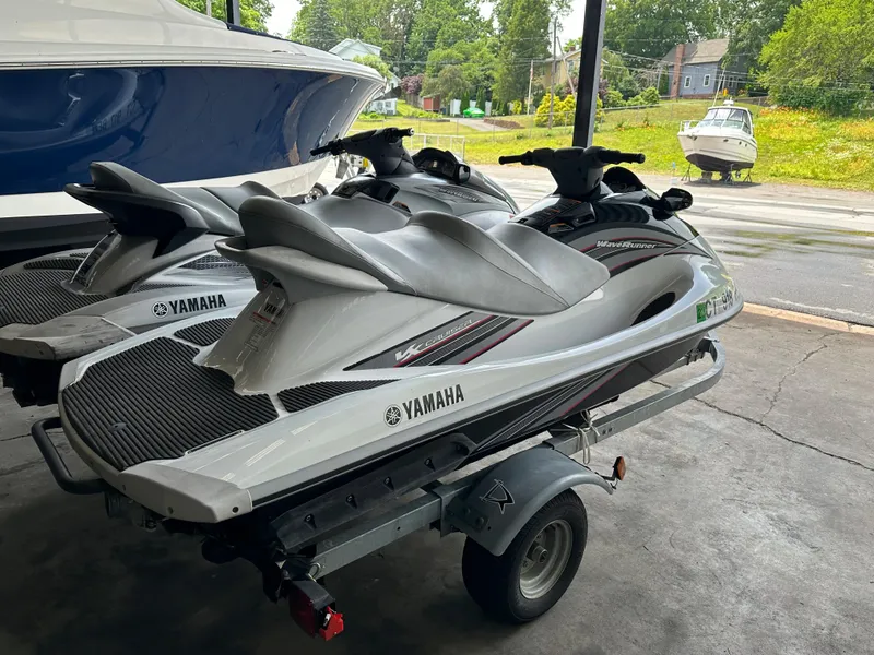Slide: The Image of 2009 Yamaha WaveRunner FX Cruiser H/O jet skis on a trailer in a garage. - 5