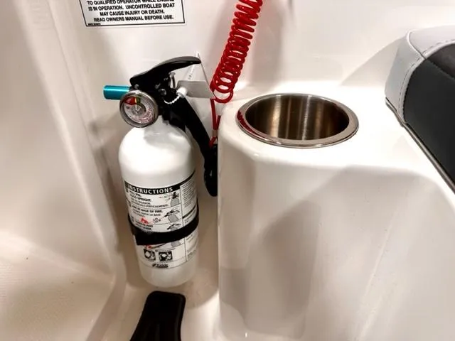 Slide: The Image of Fire extinguisher and cup holder on 2024 Bayliner Element M15 boat. - 11