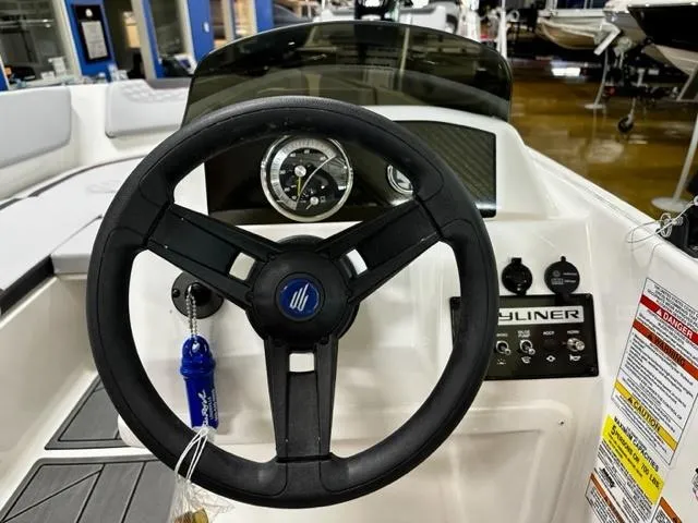 Slide: The Image of 2024 Bayliner Element M15 boat steering wheel and dashboard controls. - 8