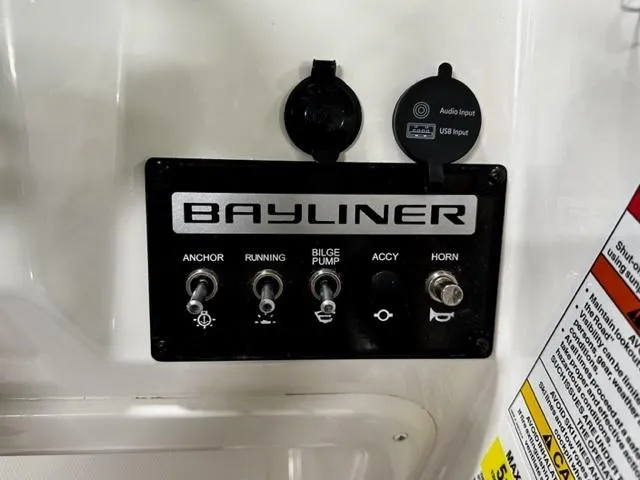 Slide: The Image of Control panel of 2024 Bayliner Element M15 boat with switches and audio input. - 9