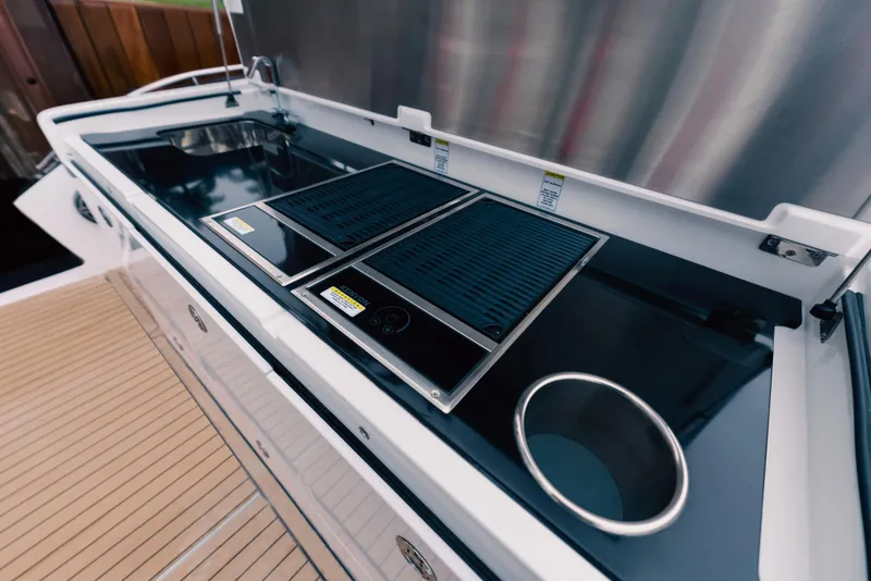 Slide: The Image of 2024 Cigarette 52 Thunder boat kitchen area with stove and sink. - 13