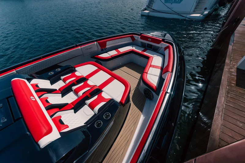 Slide: The Image of 2024 Cigarette 52 Thunder boat with luxurious red and white seating docked by the water. - 4