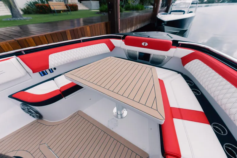 Slide: The Image of 2024 Cigarette 52 Thunder boat interior with red and white seating and a wooden table. - 5