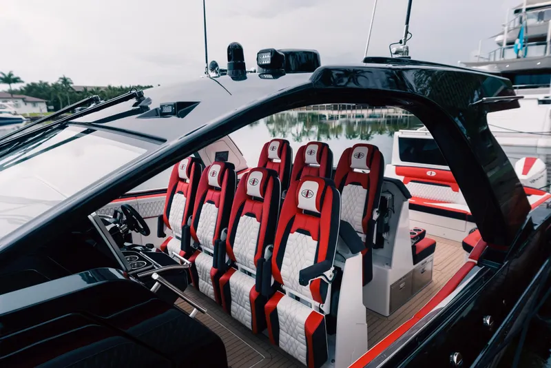 Slide: The Image of 2024 Cigarette 52 Thunder luxury speedboat interior with red and white seats. - 8