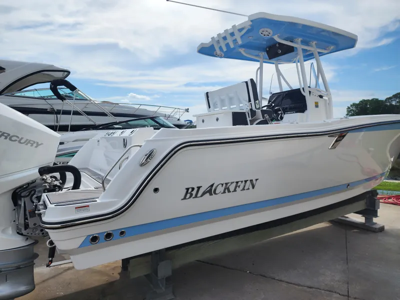 Slide: The Image of 2024 Blackfin 252 CC boat on display with Mercury outboard engine. - 3