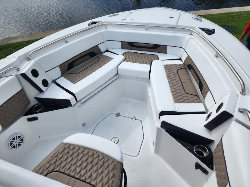 Slide: The Image of 2024 Blackfin 252 CC boat interior with cushioned seating and cup holders. - 8