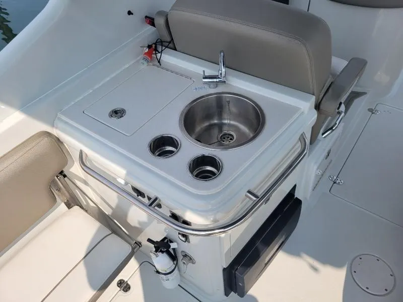 Slide: The Image of 2024 Finseeker 260 DC boat sink and prep station with faucet and storage. - 10