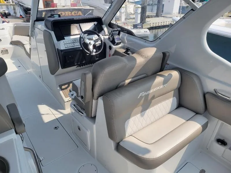 Slide: The Image of 2024 Finseeker 260 DC boat interior with modern helm and seating. - 13