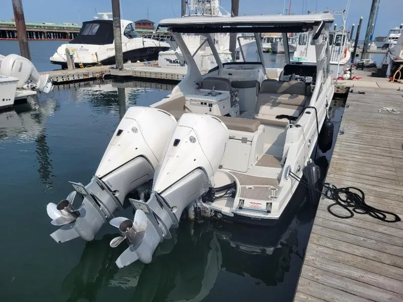 Slide: The Image of 2024 Finseeker 260 DC boat with dual outboard motors docked at marina. - 14