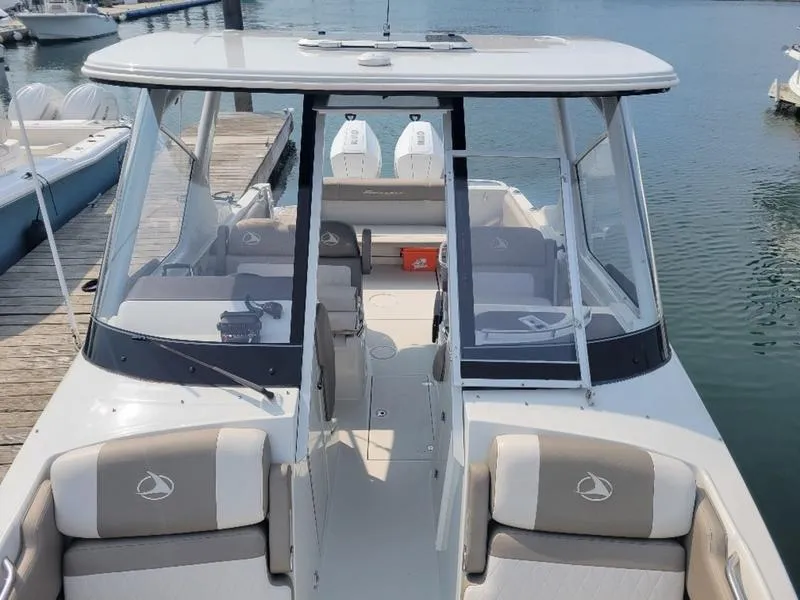 Slide: The Image of 2024 Finseeker 260 DC boat docked, showcasing spacious seating and modern design. - 17