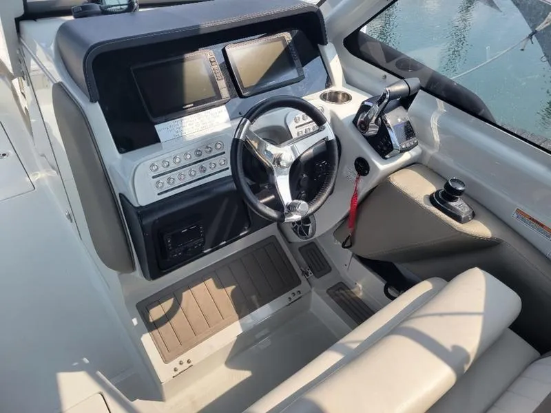Slide: The Image of 2024 Finseeker 260 DC boat cockpit with modern steering and control panels. - 2