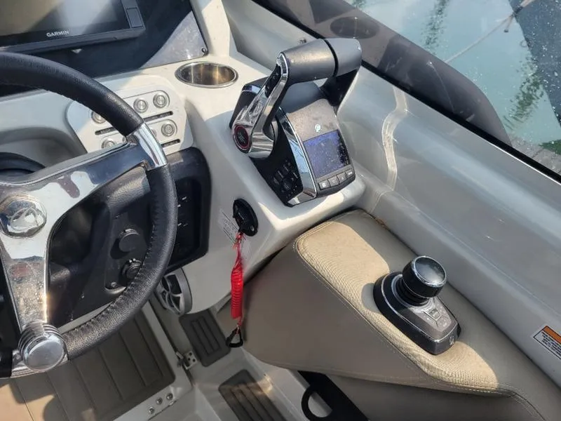 Slide: The Image of 2024 Finseeker 260 DC boat cockpit with steering wheel and controls. - 3