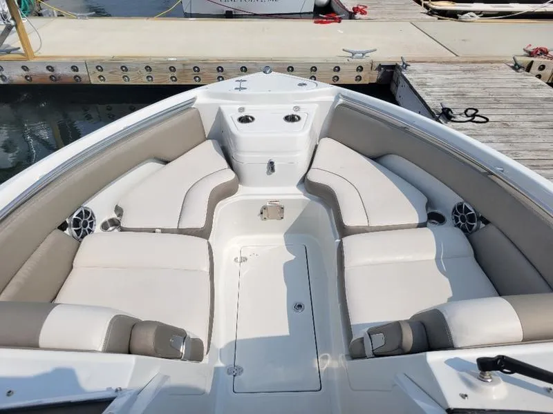 Slide: The Image of 2024 Finseeker 260 DC boat interior with plush seating at dock. - 4
