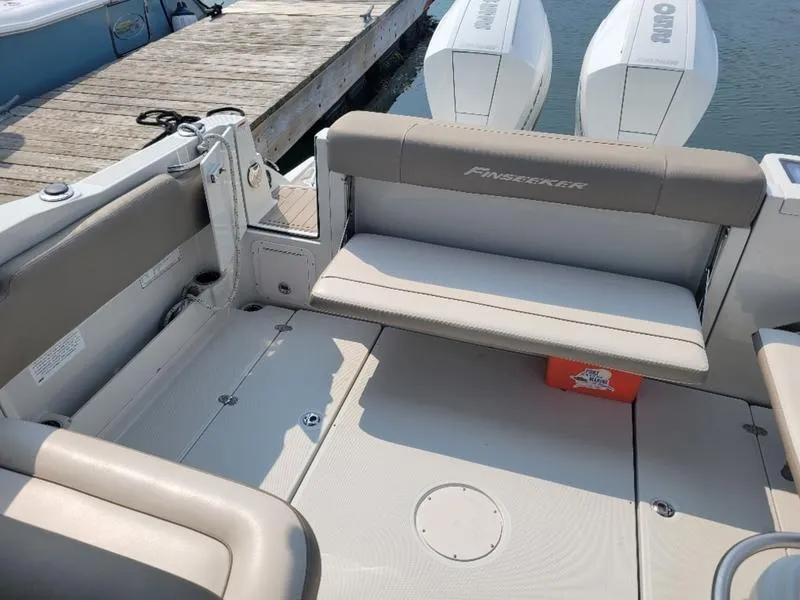 Slide: The Image of 2024 Finseeker 260 DC boat interior with seating and dual outboard engines. - 7