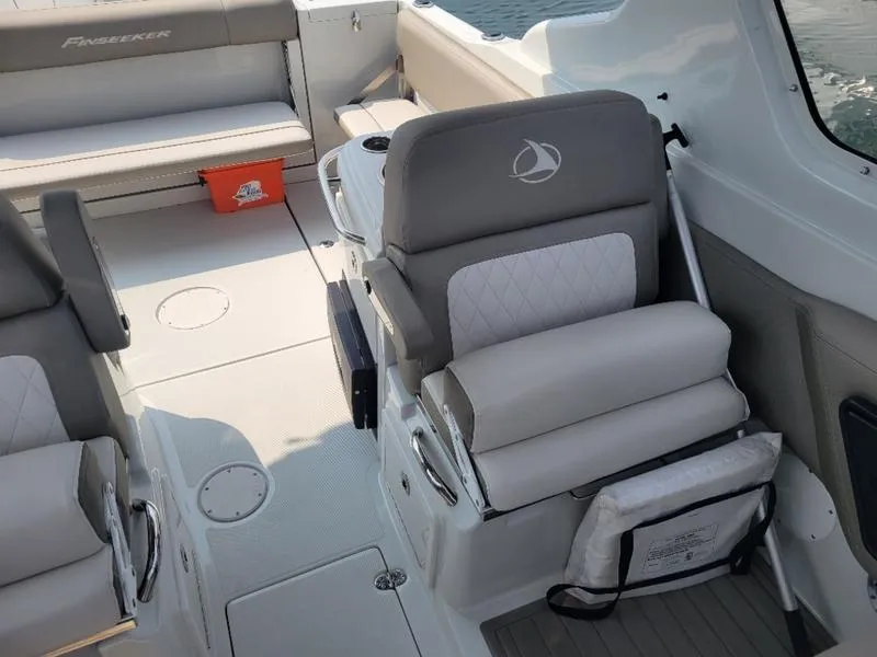 Slide: The Image of 2024 Finseeker 260 DC boat interior with cushioned seating and modern design. - 8