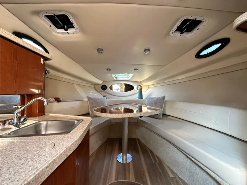 Slide: The Image of 2006 Regal Commodore boat interior with kitchenette, seating, and table. - 10