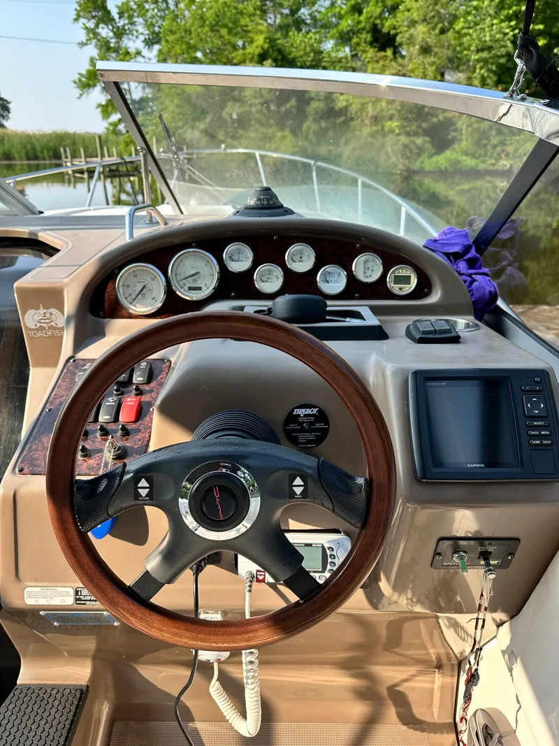 Slide: The Image of 2006 Regal Commodore boat dashboard with steering wheel and gauges. - 14