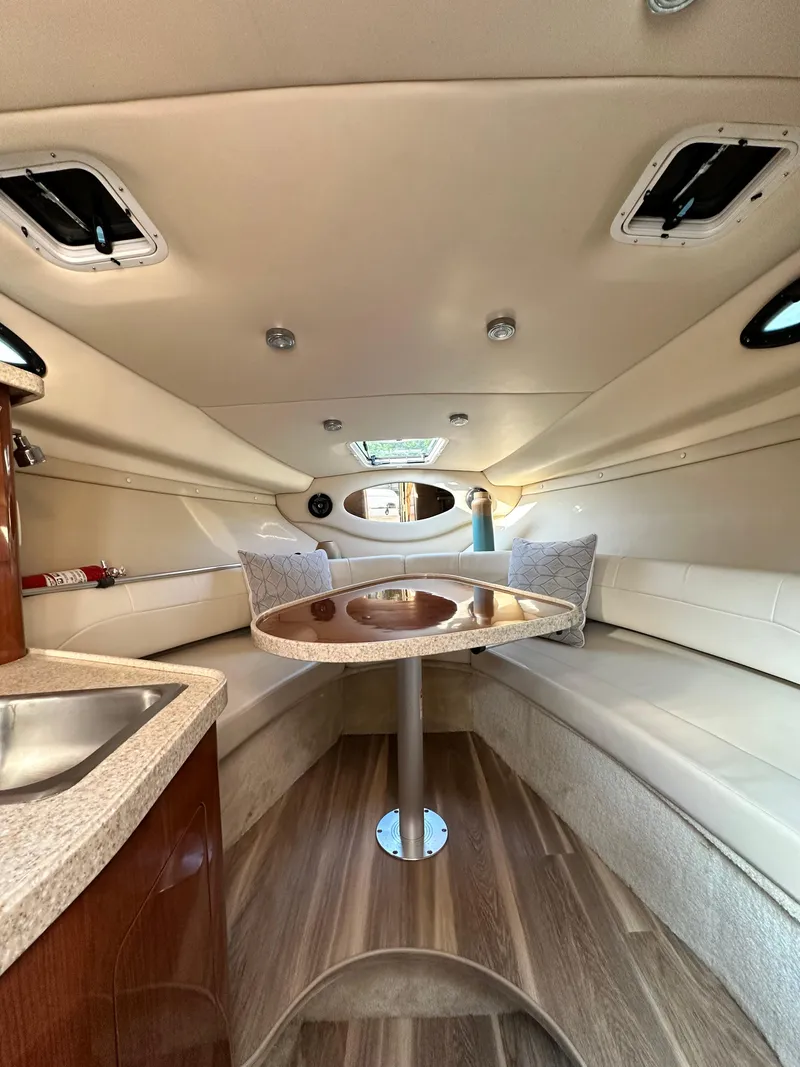 Slide: The Image of 2006 Regal Commodore boat interior with seating, table, and kitchenette. - 6