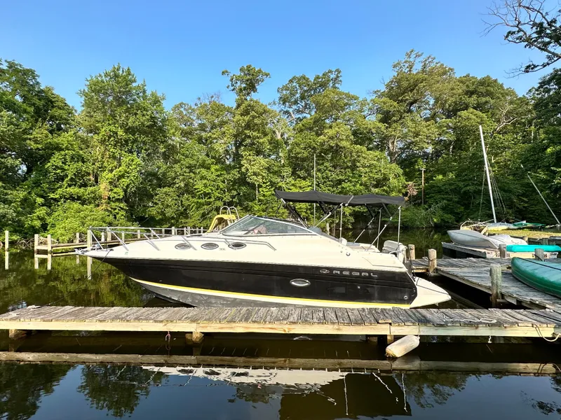 The Image of 2006 Regal Commodore boat docked in a serene marina. - 1
