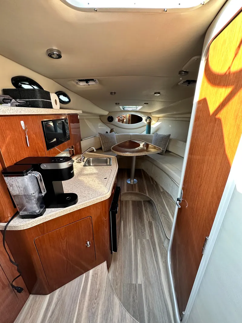 Slide: The Image of Interior of a 2006 Regal Commodore boat with kitchenette and seating area. - 11