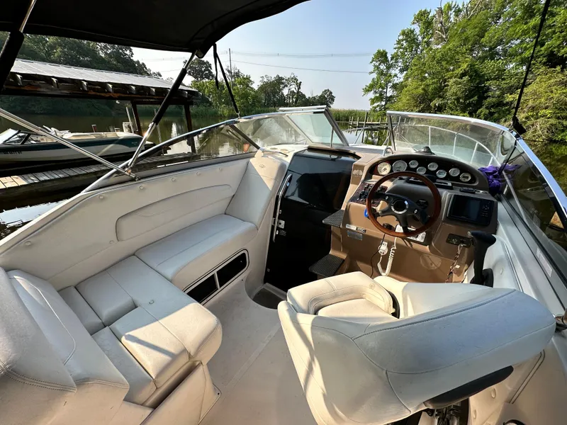 Slide: The Image of 2006 Regal Commodore boat interior with steering wheel, white seating, and dashboard controls. - 9