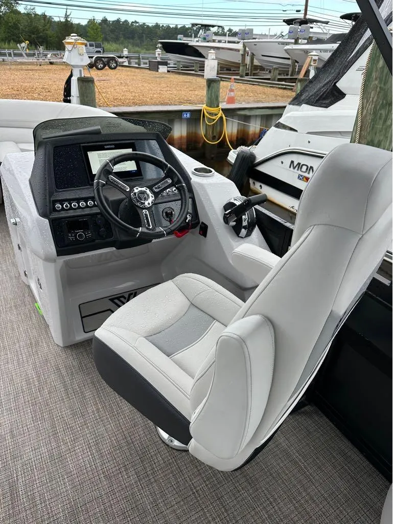 Slide: The Image of Viaggio D 23 Q 2023 boat cockpit with steering wheel and captain's chair at marina. - 4