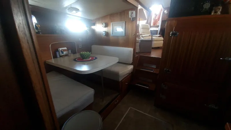 Slide: The Image of Interior of 1965 Chris-Craft 56 Roamer yacht with dining area and stairs. - 12